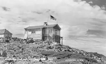 Photo shows newer BC-201 and older building in the background