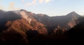 Paradise Fire shortly after lightning caused ignition - Milk Ranch Peak far right